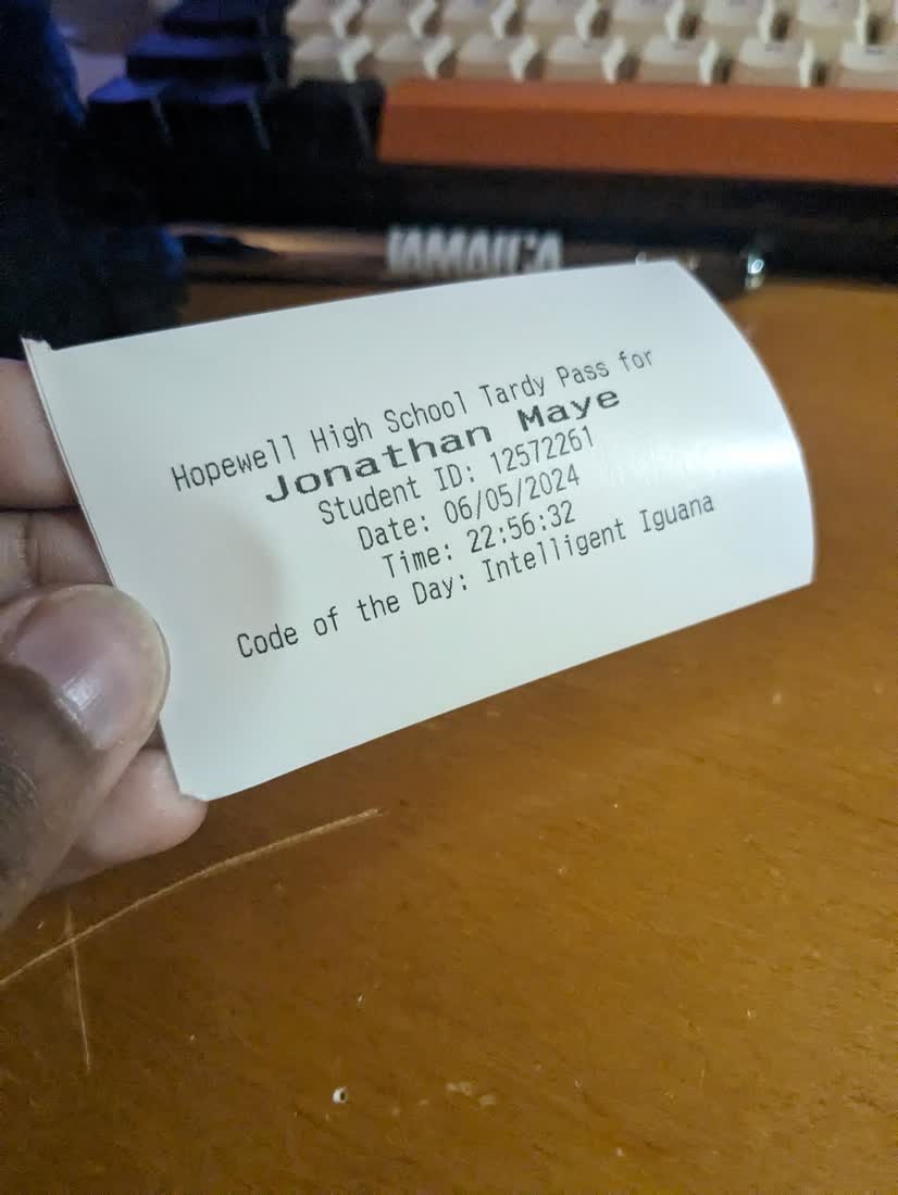 A printed pass: name, ID, timestamp, code of the day