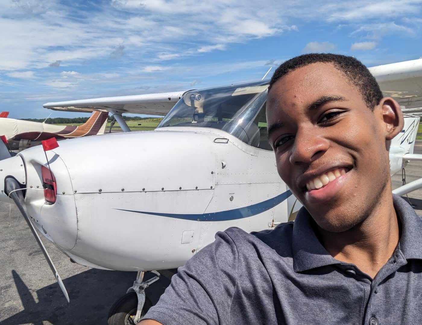 Jonathan Maye beside a Cessna at the airfield